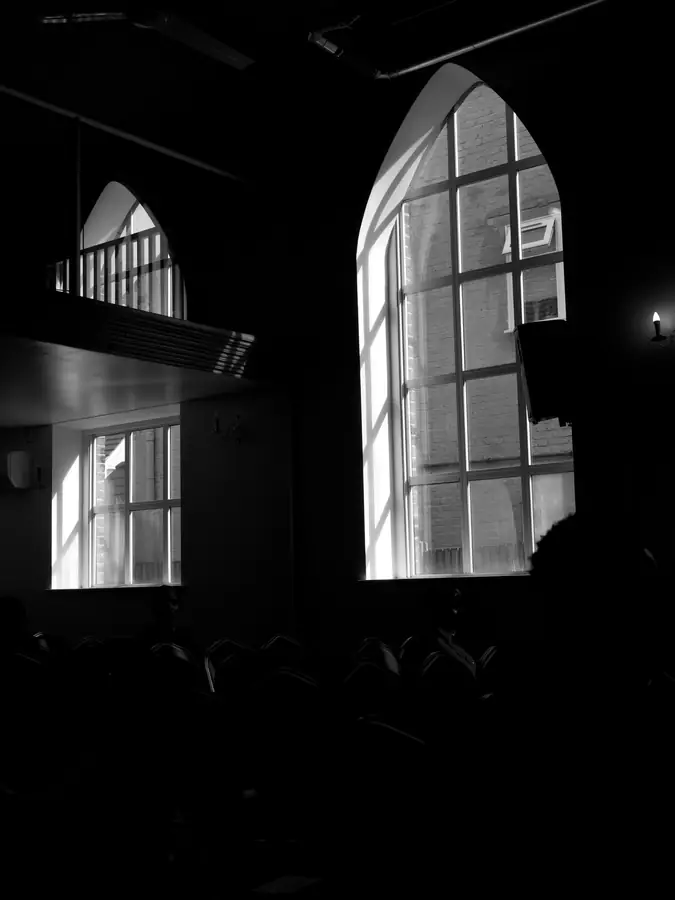 Light pouring through the arched windows of the hall